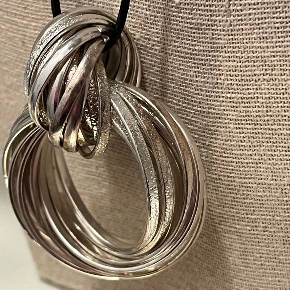 N125 Multiple hammered flat metal strips create a pendant with knot on cord - Picture 8 of 9